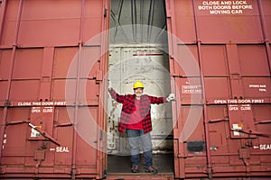 Middle Aged worker standing in industrial railway carriage