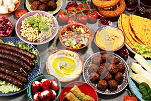 Middle eastern or arabic dishes and assorted meze, concrete rustic background. Falafel. Turkish Dessert Baklava with pistachio.