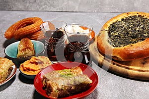 Middle eastern or arabic dishes and assorted meze, concrete rustic background. sambusak. Turkish Dessert Baklava with pistachio.