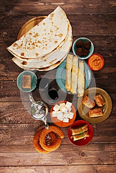 Middle eastern or arabic dishes and assorted meze, concrete rustic background. Turkish Bread or Turkish pizza. Dessert Baklava