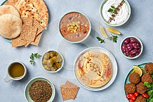 Middle eastern, arabic traditional breakfast with hummus, foul, falafel and zaatar. Top view