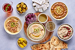 Middle eastern, arabic traditional breakfast with hummus, foul, mutabbal, qudsia and zaatar. Top view