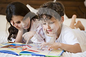 A Middle Eastern brother and sister reading