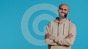 Middle eastern confident person posing on studio camera