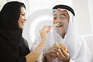 A Middle Eastern couple sharing a fast food meal