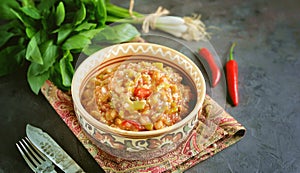 Middle Eastern cuisine - babaganush eggplant caviar from baked eggplant and pepper, with tomatoes, chili pepper, onion with oliv