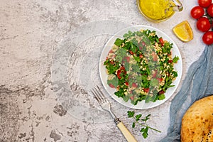 Middle Eastern cuisine. Vegetarian salad with bulgur, vegetables. Fresh bright arabic salad. Tabbouleh salad