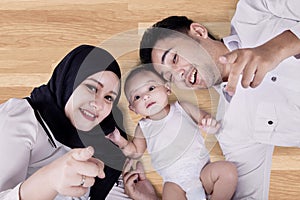 Middle eastern family lying on the floor