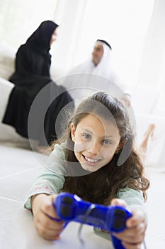 A Middle Eastern girl playing a video game