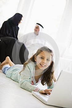 A Middle Eastern girl using a laptop