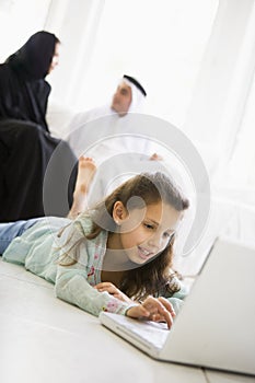 A Middle Eastern girl using a laptop