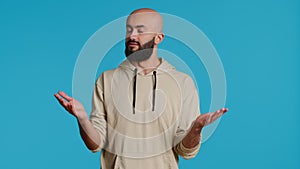 Middle eastern guy showing i dont know gesture in studio