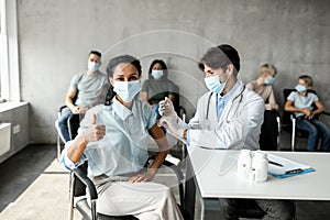 Middle-eastern lady getting vaccinated against coronavirus at clinic