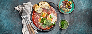 Middle Eastern and Maghrebi healthy dish Shakshouka made of eggs and tomato sauce served in pan