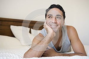 A Middle Eastern man lying on a bed