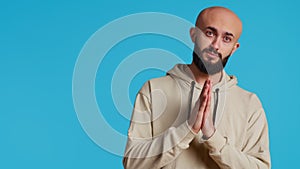 Middle eastern man praying to Allah for forgiveness