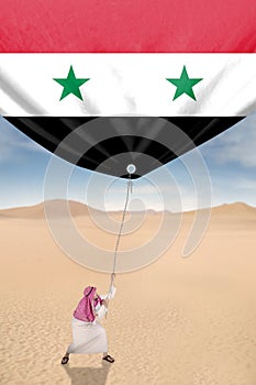 Middle eastern man pulling Syrian flag