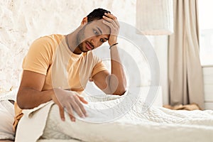 Middle Eastern Man Touching Head Having Fever And Headache Indoor