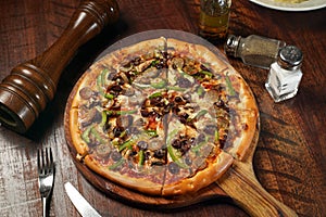 Middle Eastern Sensational Pizza isolated on cutting board top view on table italian fastfood