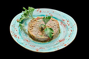 Middle Eastern snack babaganush is laid out on a plate on a black isolated background
