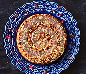 Middle eastern style walnut raisin cake in blue pottery