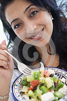 Middle Eastern woman holding a salad