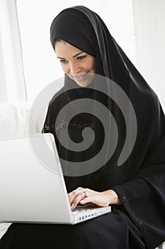 A middle eastern woman using a laptop