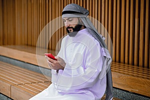 Middle eastern young man typing a message