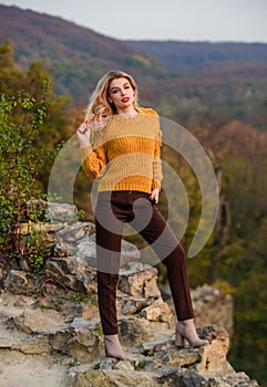 In the middle of nowhere. feeling romantic in fall. sexy woman red lipstick nature. warm and cosy seasonal clothes. girl
