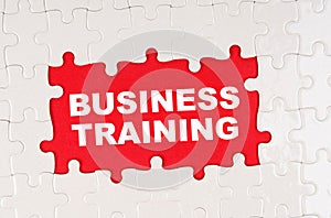 In the middle of the puzzles on a red background it is written - BUSINESS TRAINING