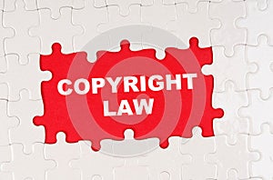 In the middle of the puzzles on a red background it is written - COPYRIGHT LAW