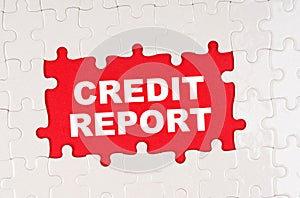 In the middle of the puzzles on a red background it is written - CREDIT REPORT
