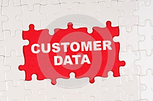 In the middle of the puzzles on a red background it is written - CUSTOMER DATA