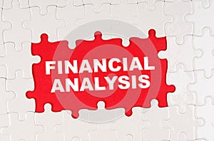 In the middle of the puzzles on a red background it is written - FINANCIAL ANALYSIS