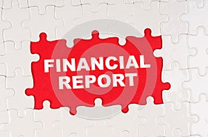 In the middle of the puzzles on a red background it is written - FINANCIAL REPORT