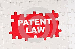 In the middle of the puzzles on a red background it is written - PATENT LAW