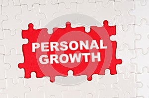 In the middle of the puzzles on a red background it is written - PERSONAL GROWTH