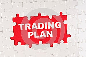 In the middle of the puzzles on a red background it is written - TRADING PLAN