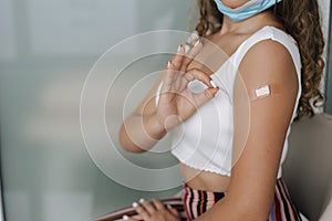 Middle seceltion of woman getting vaccinated immunity giving ok sign hand. Concept of recommended inoculation. Female