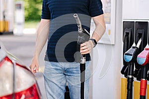 Middle selection of man refueling car at self service gas station. Petrol concept