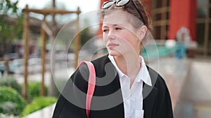 Middle shoot beautiful caucasian woman talking some thing dressed black coat standing outdoor city street.