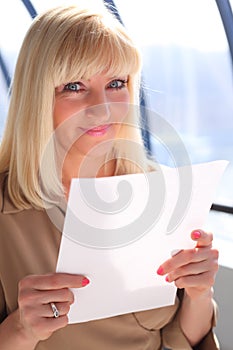 Middleaged businesswoman with sheet of paper