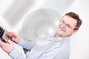 Middleaged man posing with phone