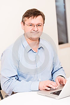 Middleaged man smiling at office