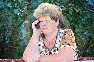 Middleaged woman talks on mobile phone