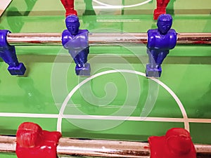 Midfielder of a red and blue football table in a game room