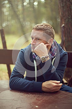 Midlife crisis man thinking portrait sitting outside photo