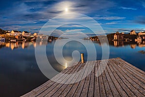 Midnight moon reflections over change Islands, Newfoundland