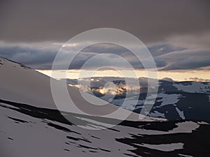 Midnight sun over the snowy mountains