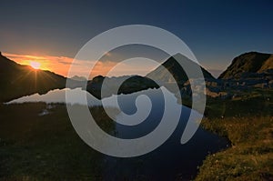 A Midnight sun scene somewhere up in the wild mountains in Lofoten